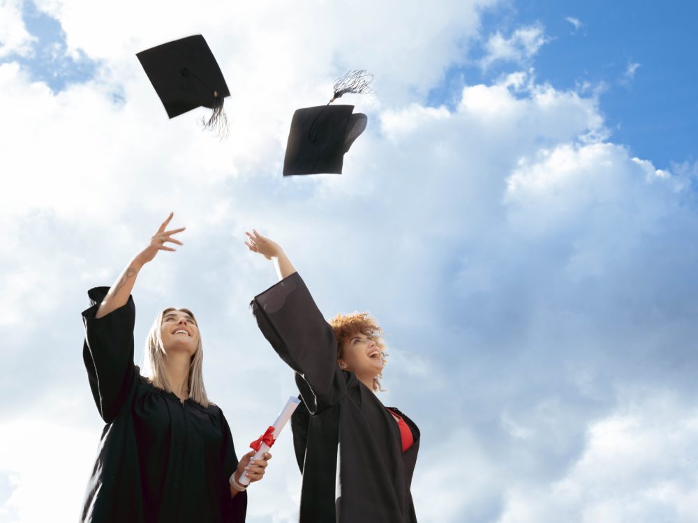 Graduate women, friends and cap in air for celebration, happiness or success for studying together .